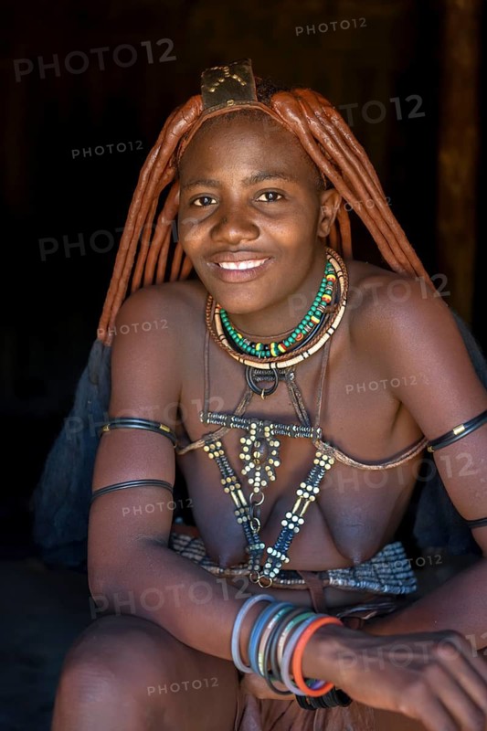 Young Himba woman in her hut, Ohandungu, Kunene region, Kaokoveld, Namibia