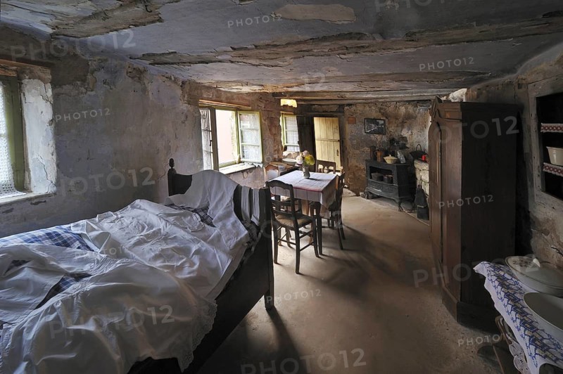 Interior of troglodyte house in rock face at Graufthal, Vosges, Alsace, France