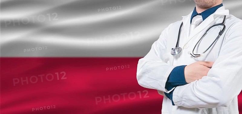 Poland Health and Care concept. Male doctor on Poland flag. Doctor with crossed arms on Poland flag