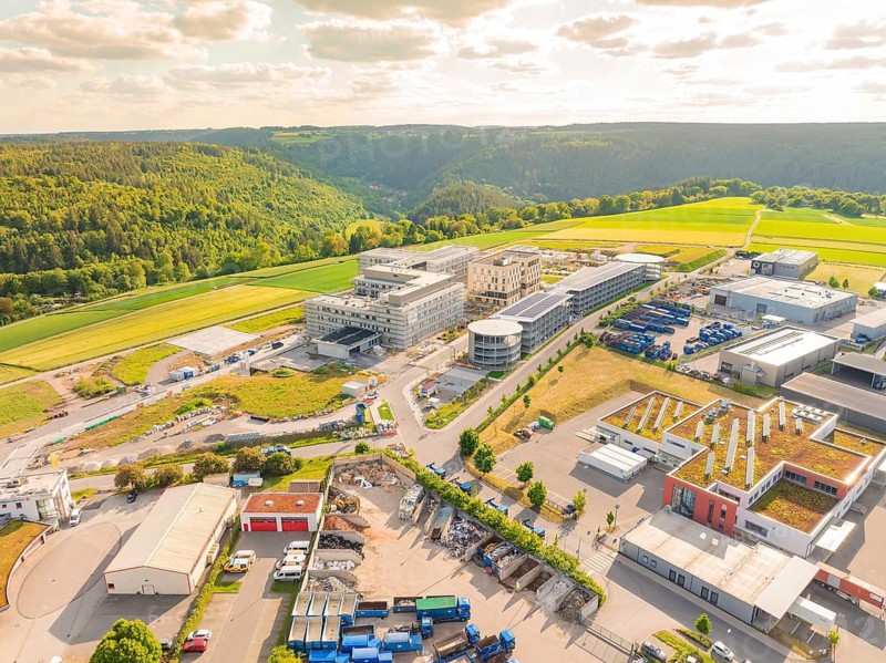 Industrial area with various buildings embedded in a hilly landscape, construction of the new hospital Gesundheitscampus Calw, Germany