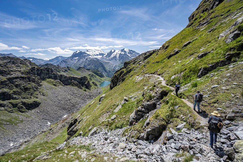 Mountaineer on hiking trail in mountain landscape, descent at Col du Louvie, view of the summit of the Grand Combine, Valais Alps, Val de Bagnes, Valais, Switzerland