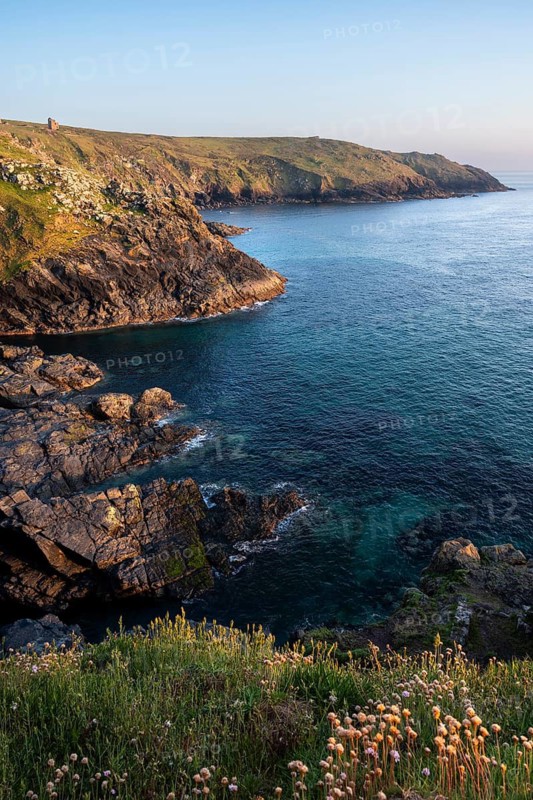 Coastal landscape at Botallack Mine, also known as Crown Mine. The ruins of Wheal Edward in the background. Evening, golden hour. Botallack, Penzance, Cornwall, England, Great Britain