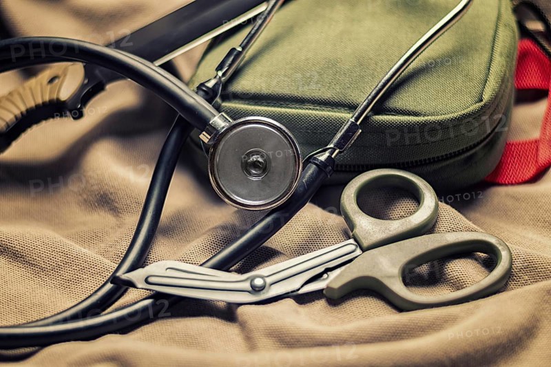 Stethoscope lies on the uniform of a US soldier. The concept of health care, military insurance, state care. Top view.