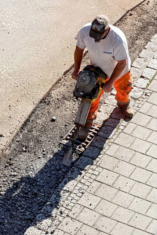 Construction worker with chipping hammer, chisel hammer, repair of road surface, asphalt, road construction, Marzling, Upper Bavaria, Bavaria, Germany
