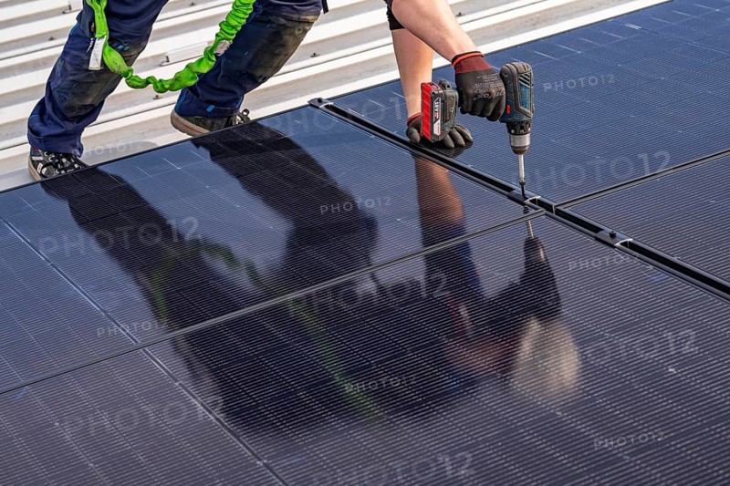 Installation of solar modules on the roof of a commercial enterprise, over 400 photovoltaic modules are installed on the roof, North Rhine-Westphalia, Germany