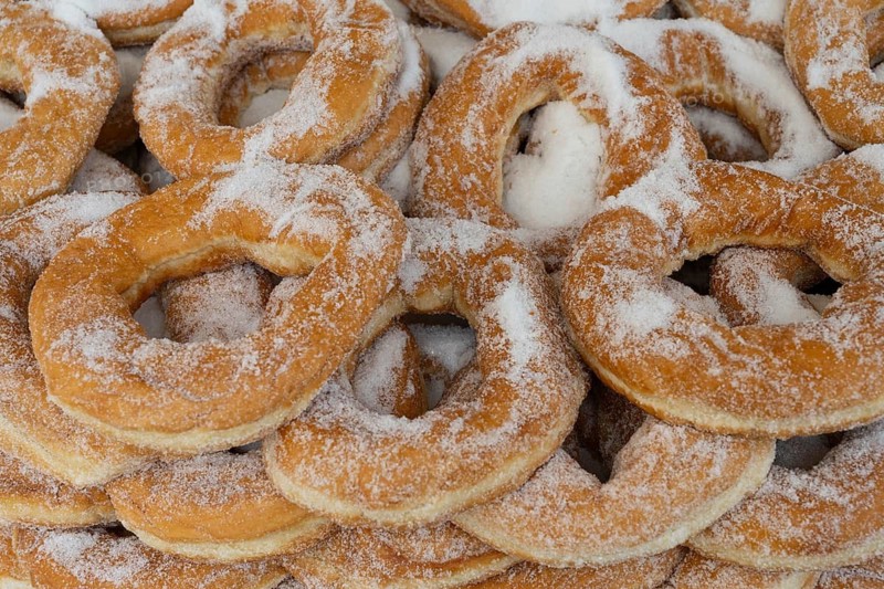 Traditional Greek doughnuts are a pastry and popular street food snack sold from street carts and bakeries in Greece, a tasty sweet desert
