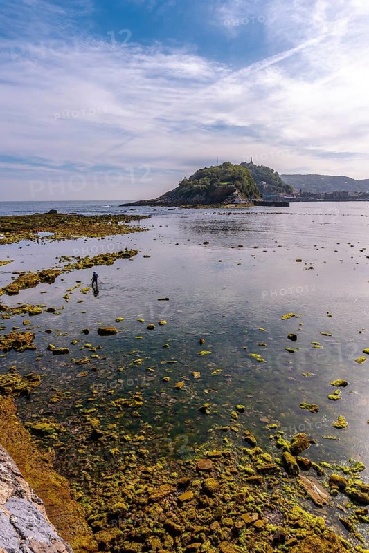Low tide on the beach of Ondarreta in San Sebastián and the island in the background. Province of Gipuzkoa, Basque Country. Spain