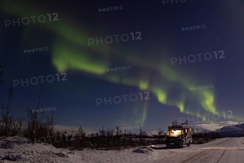 Motorhome under northern lights in winter, Finnmark, Norway