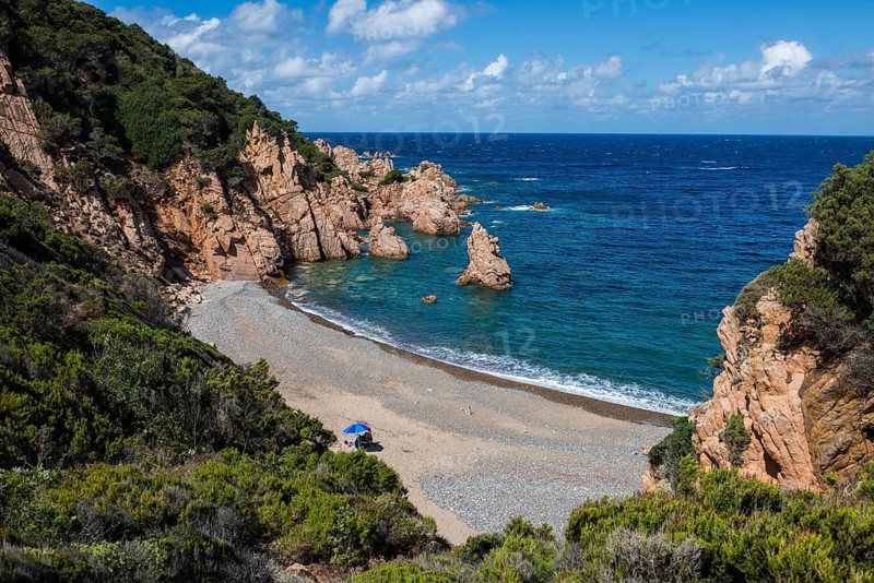Red rocks and secluded beach, Spiaggia di Tinnari, Costa Paradiso, Sardinia, Italy