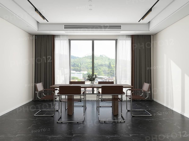 Modern living room featuring sleek metal chairs and a wooden table, enhanced by natural light from a large window with scenic views, ideal for meetings