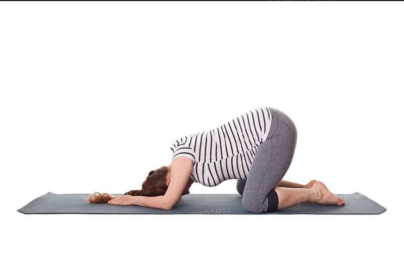 Pregnancy yoga exercise, pregnant woman doing asana Balasana, child s pose isolated on white background