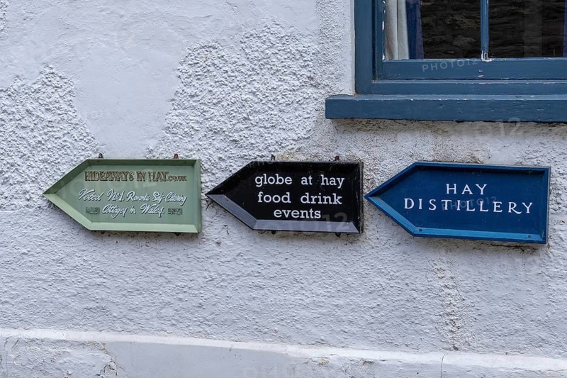 Signpost on house wall, Hay-on-Wye, Wales, Great Britain