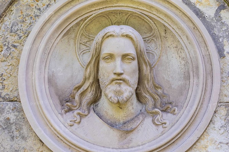 Head of Christ as a medallion at the cemetery in Lichtenstein, Saxony, Germany