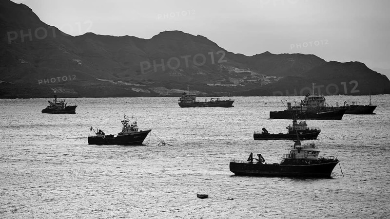 Monochrome, several ships floating on the sea off a mountainous coastline in a black and white image, Mindelo Harbour, Sao Vicente, Cabo Verde, Cape Verde, Cape Verde