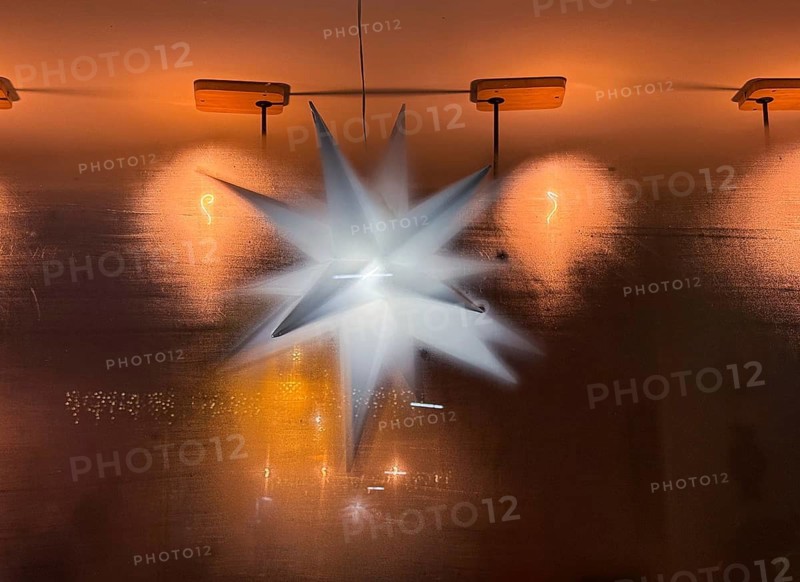 View through a steamed-up window of a café to an illuminated poinsettia, atmospheric lighting and decoration, Düsseldorf, Germany