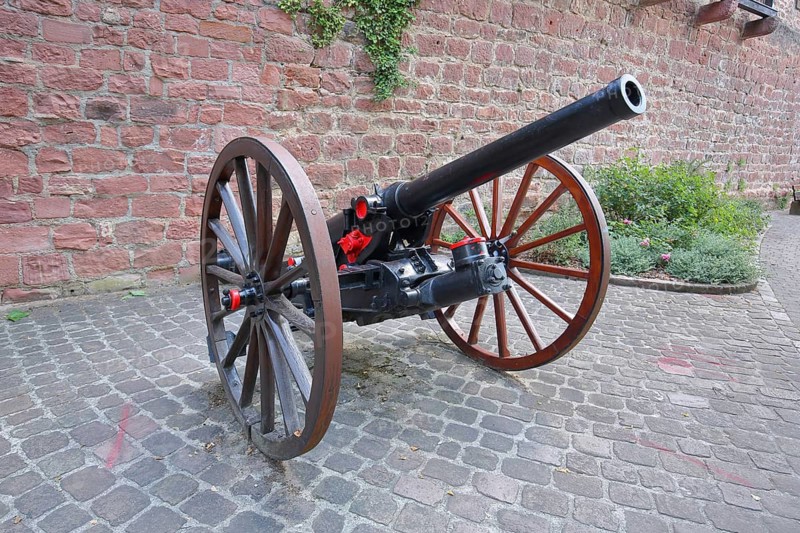 Medieval cannon with wagon wheels in front of the city wall at Pulverturm, Eberbach, Neckar Valley, Baden-Württemberg, Germany
