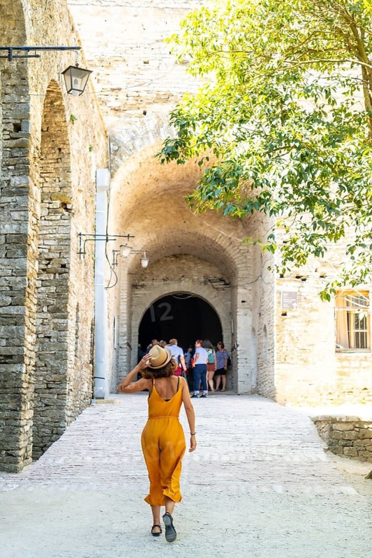 A woman walking in the arches of the fortress of the Ottoman castle of Gjirokaster or Gjirokastra. Albanian
