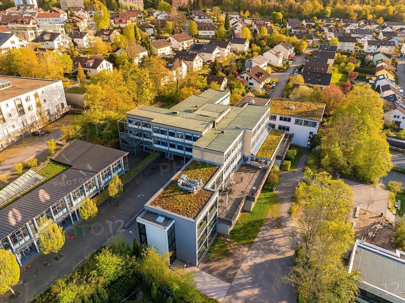 Urban landscape with modern groups of buildings and green roofs seen from the air, Christiane Herzog Realschule, Nagold, district of Calw, Germany