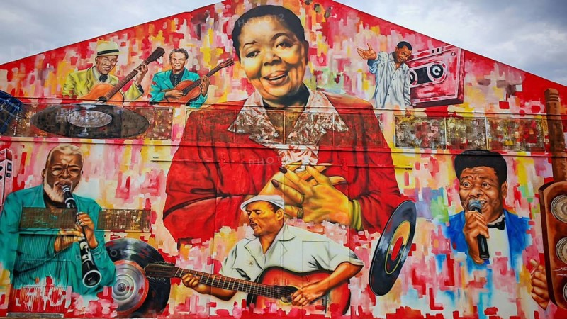 Vivid mural, mural, graffiti with portraits of musicians, Cesaria Evora, and various musical instruments, hangar, warehouse at Mindelo Harbour, Sao Vicente Cabo Verde, Cape Verde, Cape Verde
