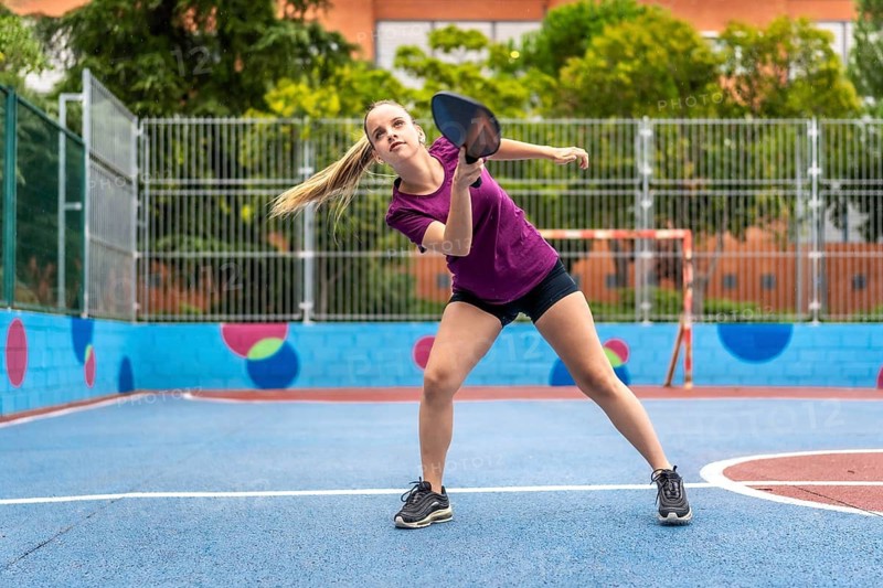 Female caucasian young pickelball player in an outdoor court