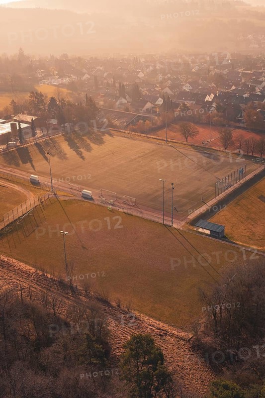 View from above of a sports field and an adjacent settlement, Gechingen, Calw district, Germany