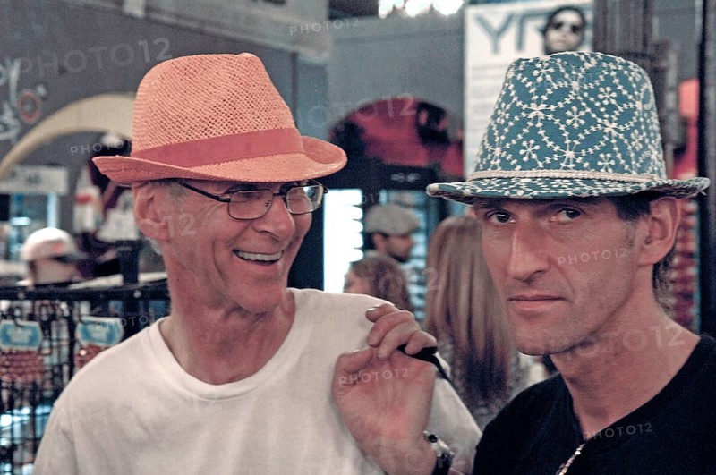 Young men poke hats for fun in a department store, New York, USA