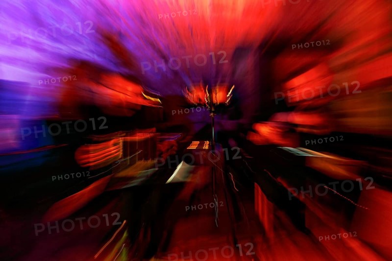 Dynamic stage set at a milonga, concert, tango dance event, motion blur, format-filling, orange, blue, symbolic image, Germany