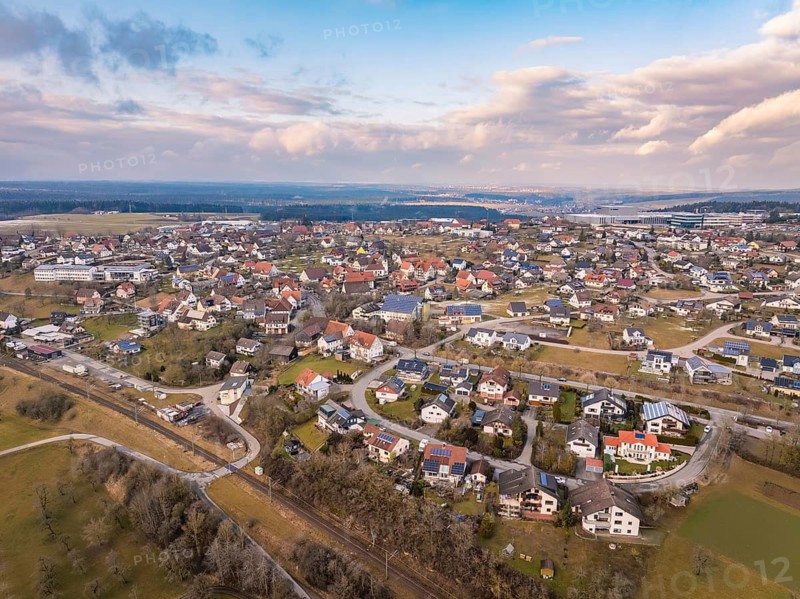 Built-up residential area in a picturesque landscape under a cloudy sky, Schopfloch, Freudenstadt district, Germany