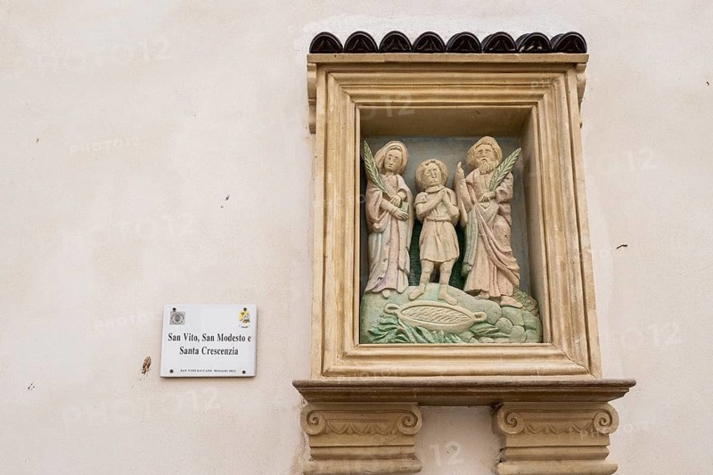 Sculpture of a saint on a house wall, San Vito Lo Capo, Sicily, Italy