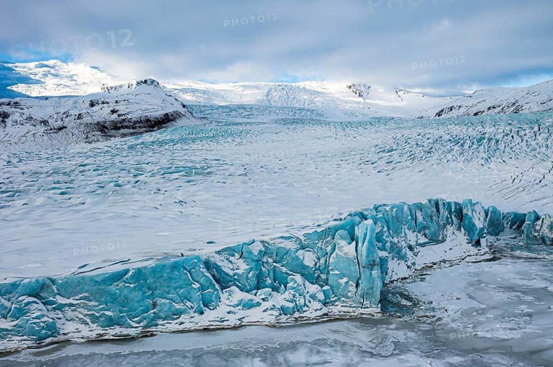 Glacier break in the glacier lagoon Fjallsarlon, behind it the Öraefajökull glacier, drone shot, Sudurland, Iceland