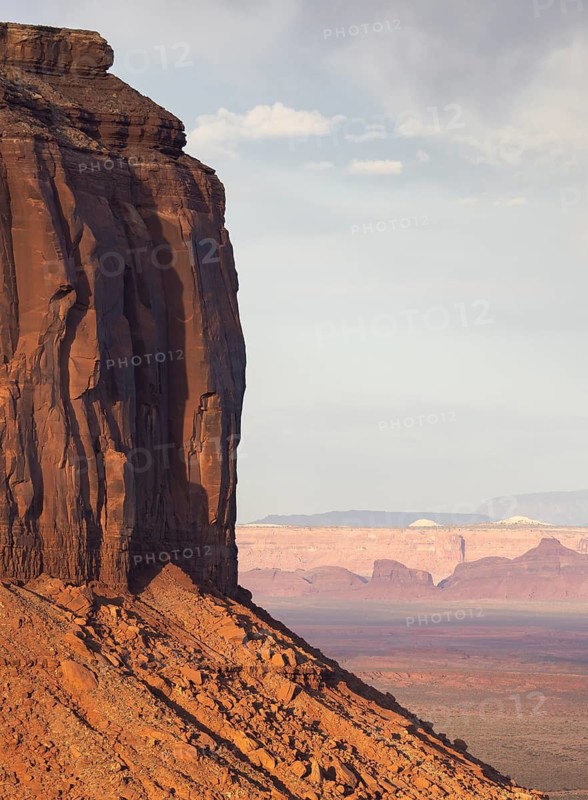 Stunning red rock formations dominate the landscape of Monument Valley. The towering cliffs and vast desert backdrop create an iconic view of this American Southwest wonder