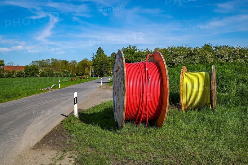 Bönen, North Rhine-Westphalia, Germany - Internet broadband expansion in the countryside, construction site for laying fibre optic cable, cable drum with fibre optic cable, new construction of fibre optic routes, fast Internet, DSL cable connection for households. Bönen is a municipality in the district of Unna in North Rhine-Westphalia