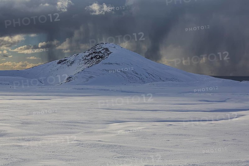 Cloudy mood and snowstorm over an old volcano, snow, winter, Neshraun, Snaefellsnes, Vesturland, Iceland
