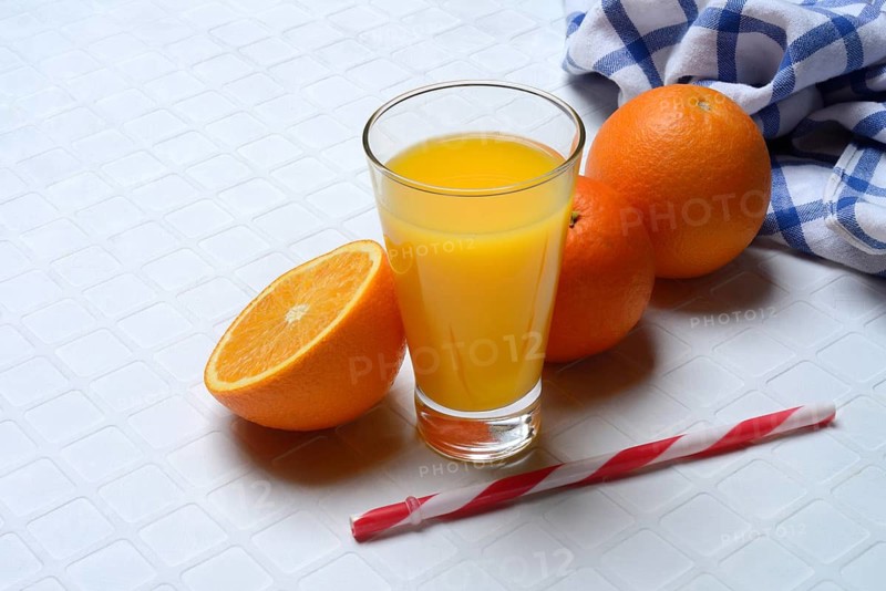 Orange juice in glass and orange