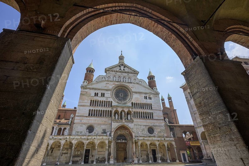 View of the Cathedral of Santa Maria Assunta from café under arcades, Cremona, Province of Cremona, Italy