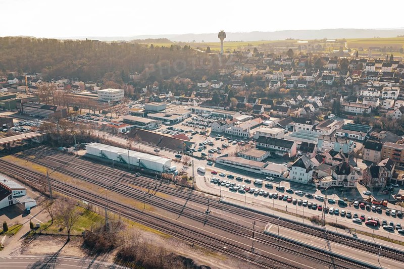 City overview with residential areas, railway tracks and parking spaces in front of a hill, Mühlacker, Enzkreis, Germany