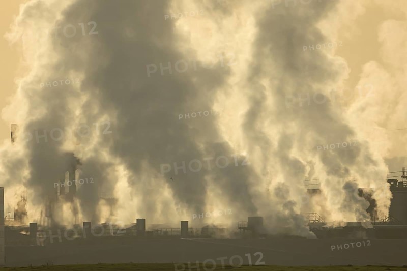 Chinmneys emitting steam or smoke from an industrial plant, England, United Kingdom