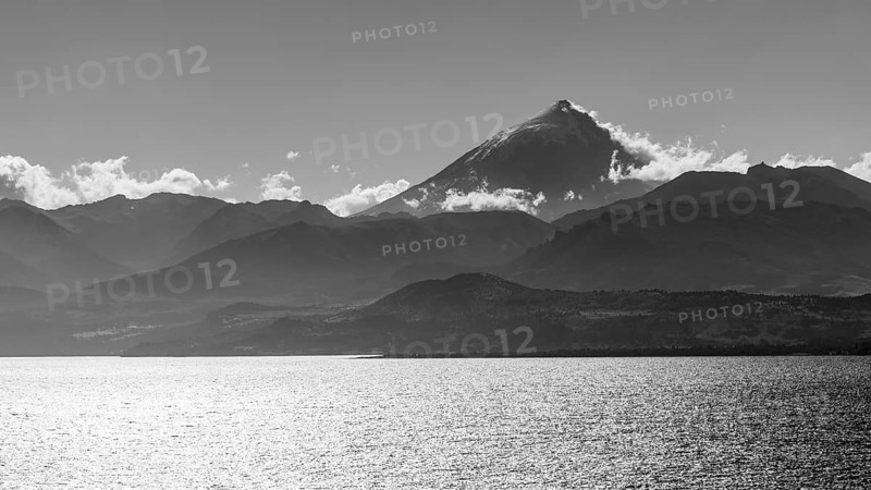 Black and white photograph of Lake Huechulafquen with the Lanin volcano against the light, Lanin National Park, Patagonia, Argentina