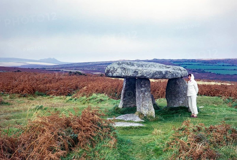 Woman in front of the prehistoric dolmen Lanyon Quoit, Morvah, Cornwall, England, UK 1967
