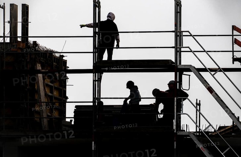 Construction site, scaffolding work on a large construction project, apartments and commercial premises, symbolic image of the construction industry