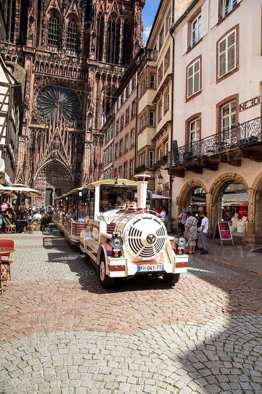 Sightseeing tour with the tourist train in the historic centre of Strasbourg In the background the famous Strasbourg Cathedral