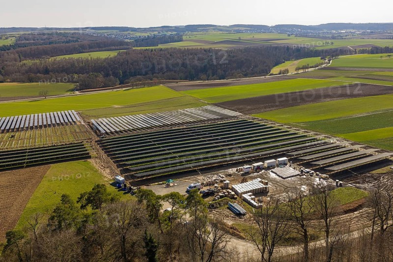 View of a large solar plant surrounded by fields and green hills, Agri PV Bau für Landwirtschaft, Enzkreis, Germany