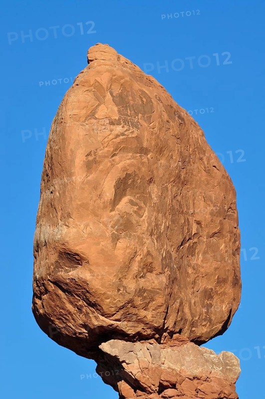 Close-up of a large, balanced boulder, Balanced Rock, against blue sky, Arches National Park, Utah, USA