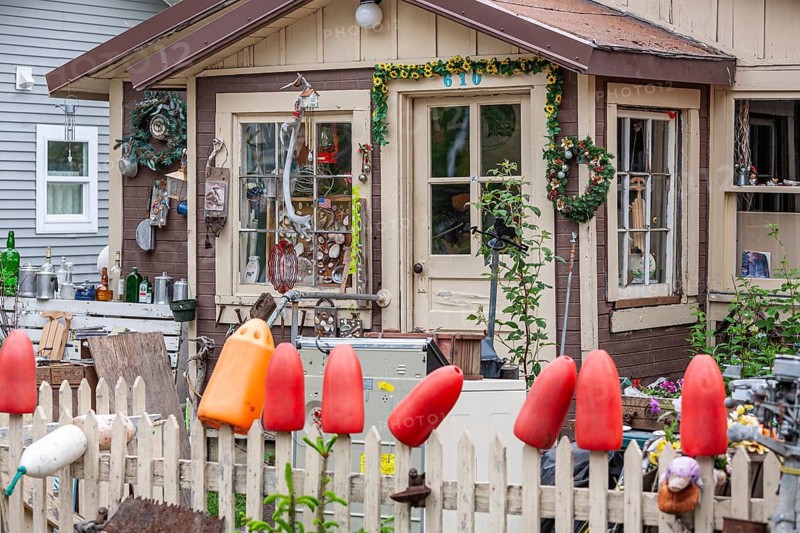 Art collection and crafts in front of a wooden house, shells, buoys, glass, Seward, Alaska, USA
