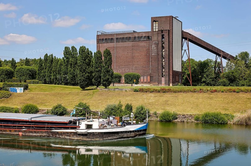 30.07.2022, Gelsenkirchen, North Rhine-Westphalia, Germany, Nordsternpark, here with the building of the coal mixing plant of the former Nordstern colliery on the Rhine-Herne Canal. Parks and gardens in the Ruhr area. Nordsternpark is a landscaped park on the site of the former Nordstern colliery in Gelsenkirchen. Following the closure of Nordstern colliery in 1993, the site was completely renovated and transformed into a landscape park. The Federal Garden Show was held in the park in 1997. The site will be further redesigned as part of the IGA 2027. 00X220730D008CARO (MODEL RELEASE: NO, PROPERTY RELEASE: NO (c) caro images / Rupert Oberhaeuser, http://www.caro-images.com, info@caro-images.com, If the photo is used for purposes other than journalism, please contact the agency, Any use of the photo is subject to a fee !)