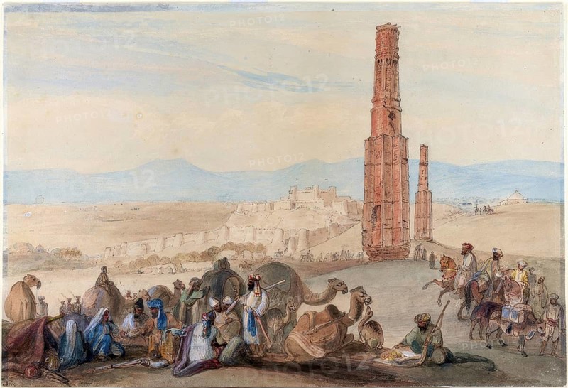 Caravan with camels in front of ruins and a vast landscape