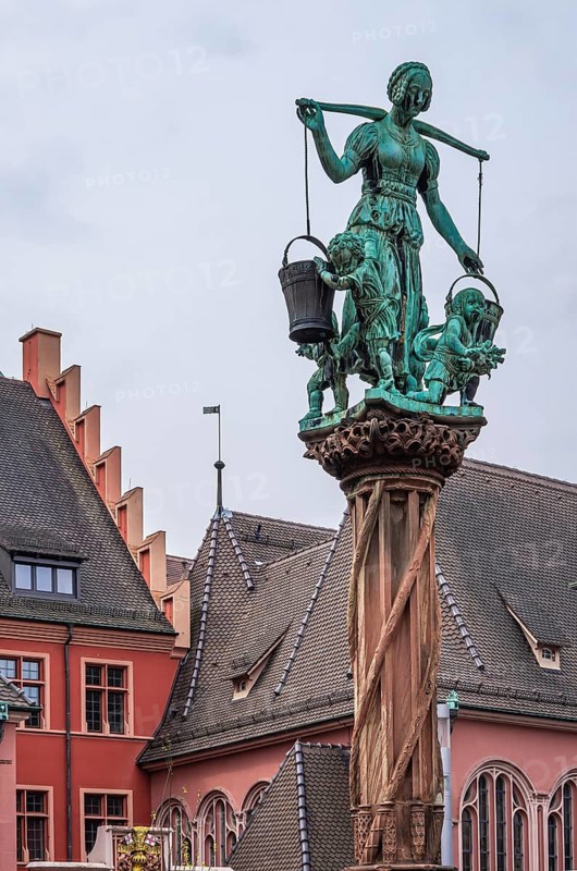 Scene with water bearer on the robber fountain in the historic old town of Freiburg im Breisgau, Baden-Württemberg, Germany
