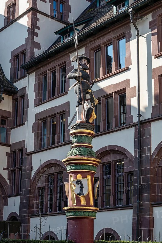 The Sevogelbrunnen on Martinskirchplatz in the old town of Basel with the statue of a warrior from the Renaissance era, Canton of Basel-Stadt, Switzerland