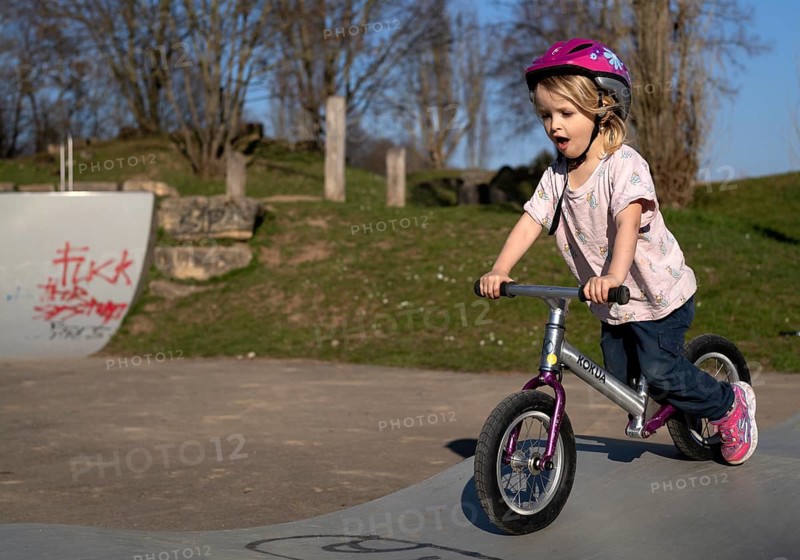 Little girl, 3 years old, blonde, riding a balance bike, crash helmet, playground, Stuttgart, Baden-Württemberg, Germany