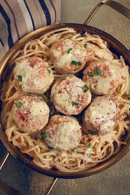 Spaghetti with chicken meatballs, with cream sauce, and parmesan cheese, and decorated with microgreens, homemade, no people